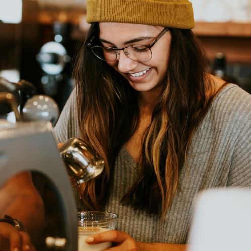 Bustling community with plenty of dining choices a woman in a hat